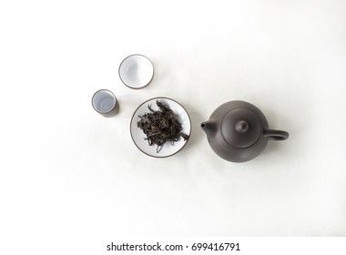 snuff cup with black tea, gaivan and a tea cup on a white backgroun