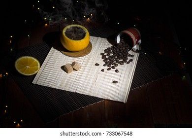 Coffee made in an orange peel on a bamboo napkin with browny sugar