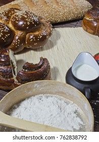 Bread composition with milk and flour on a wooden background